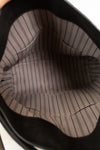 Close-up of a brown pinstripe fabric inside a handbag