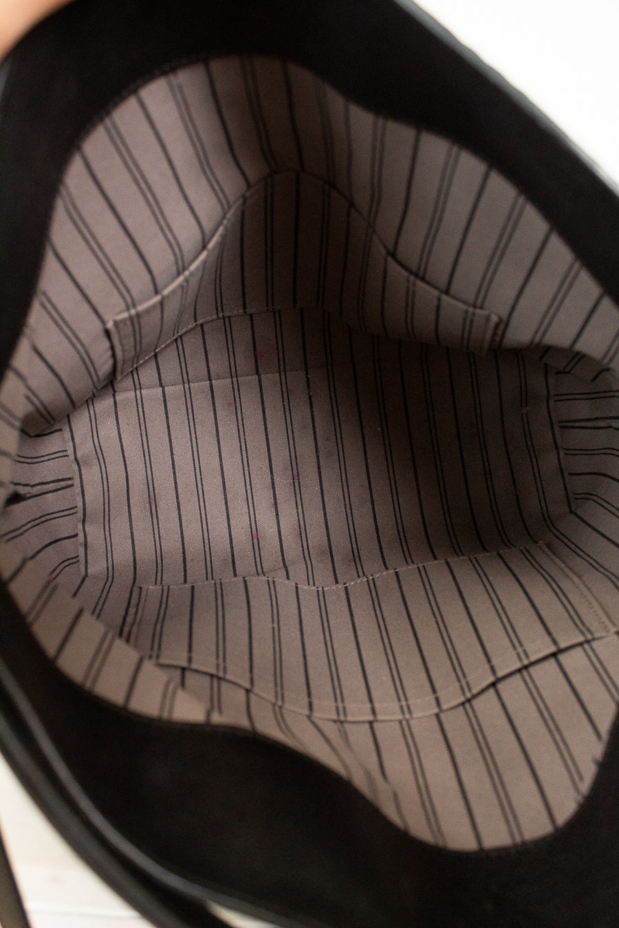 Close-up of a brown pinstripe fabric inside a handbag