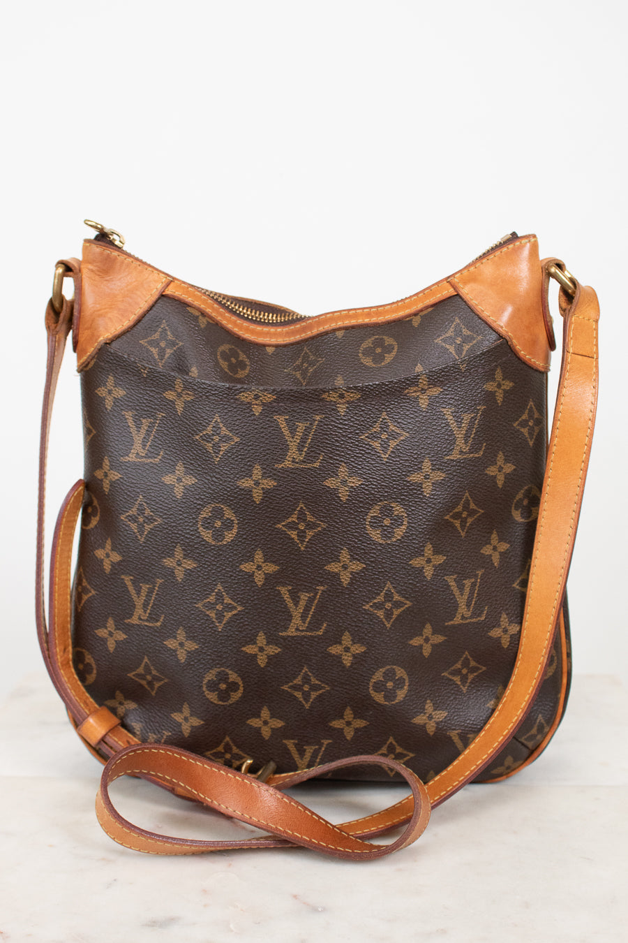 A Louis Vuitton monogram shoulder bag in brown coated canvas with tan leather trim and a matching adjustable shoulder strap, photographed against a plain light background.