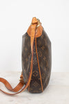 A Louis Vuitton monogram coated canvas shoulder bag shown from a side profile view, featuring the classic brown and tan monogram pattern with a tan leather trim and strap, set against a plain white background.