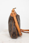 A Louis Vuitton monogram coated canvas shoulder bag shown from the side, featuring brown coated canvas with tan monogram motifs and light brown leather trim and strap, set against a plain white background.