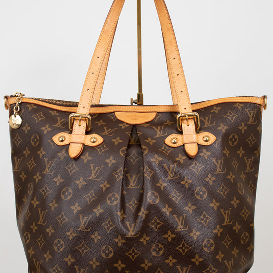 Designer handbag with monogram pattern on a white background