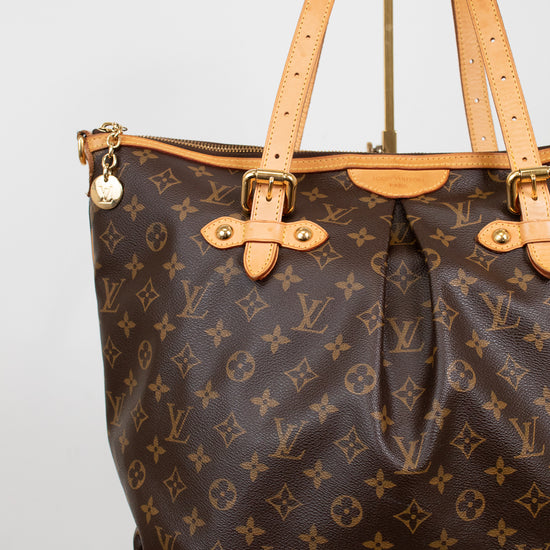 Louis Vuitton handbag with monogram pattern on a white background