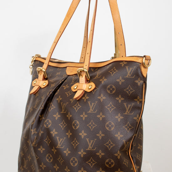 Designer handbag with monogram pattern on a white background