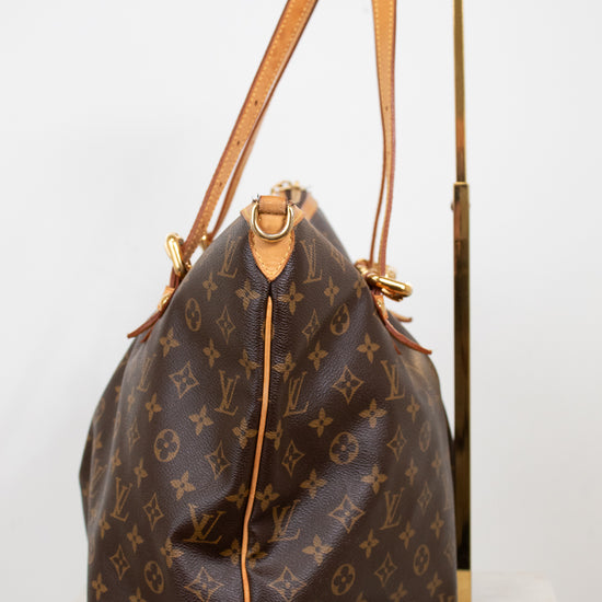 Designer handbag with monogram pattern on a white background