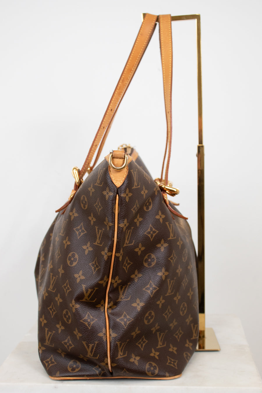 Designer handbag with monogram pattern on a white background