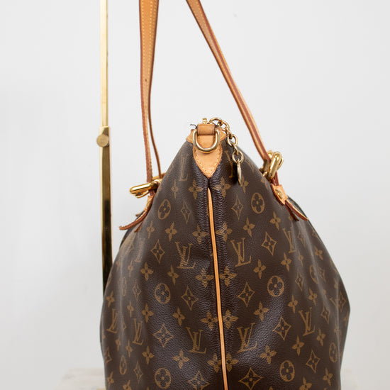 Designer handbag with monogram pattern on a white background