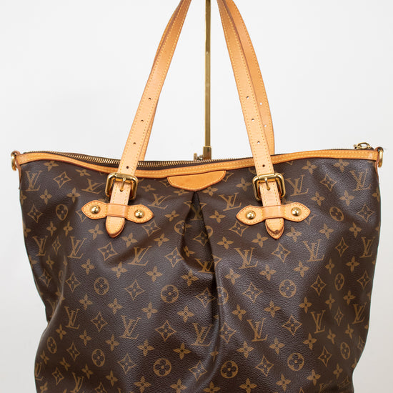 Designer handbag with monogram pattern on a white background