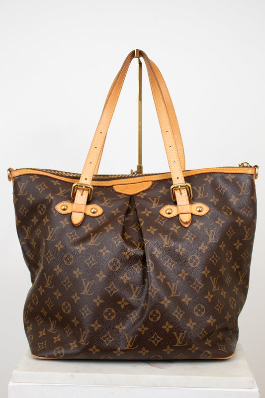 Designer handbag with monogram pattern on a white background