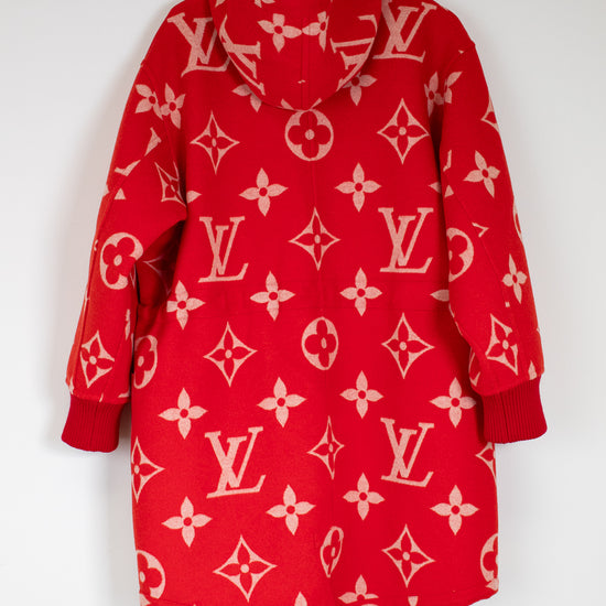 Red hoodie with pink patterns on a hanger against a white background