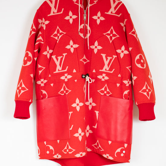 Red hoodie with pink patterns on a hanger against a white background