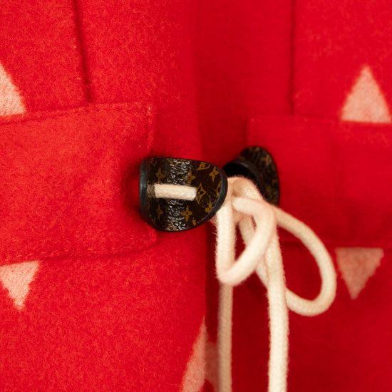 Close-up of a red fabric with a button and white drawstring on a red background