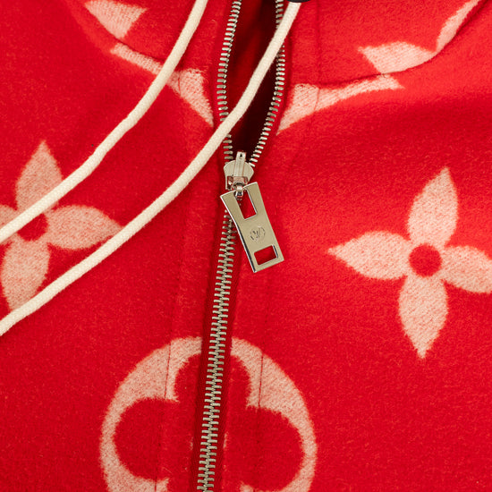 Close up of silver zipper on red coat with pink monogram logo