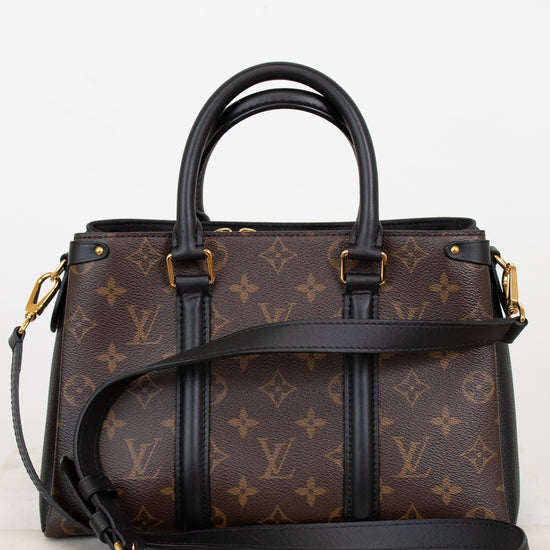 Designer handbag with monogram pattern on a light background