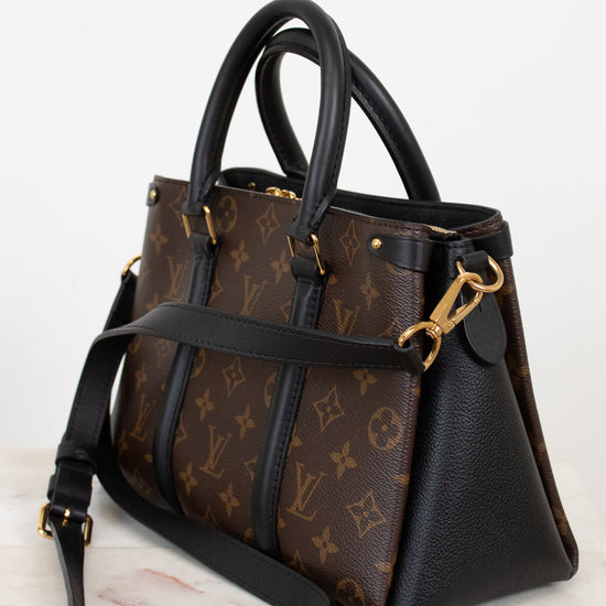 Designer handbag with monogram pattern on a white background