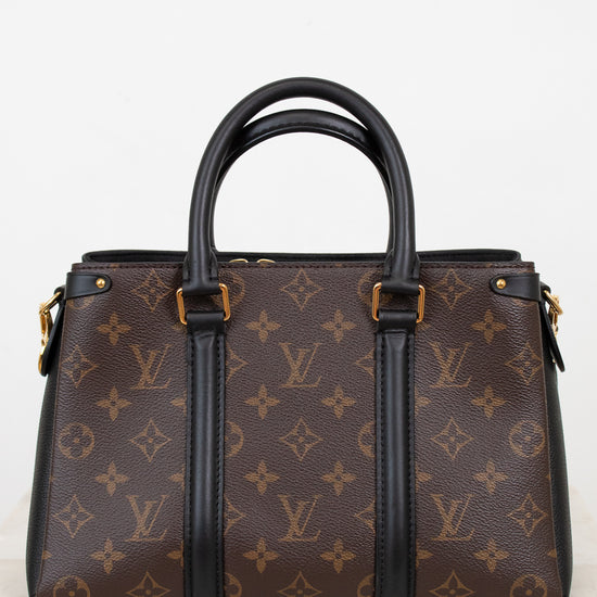 Brown monogram handbag with black handles and trim on a white background