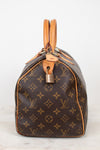 A Louis Vuitton monogram canvas Speedy bag in dark brown with tan leather trim and handles, shown from the side against a plain white background.