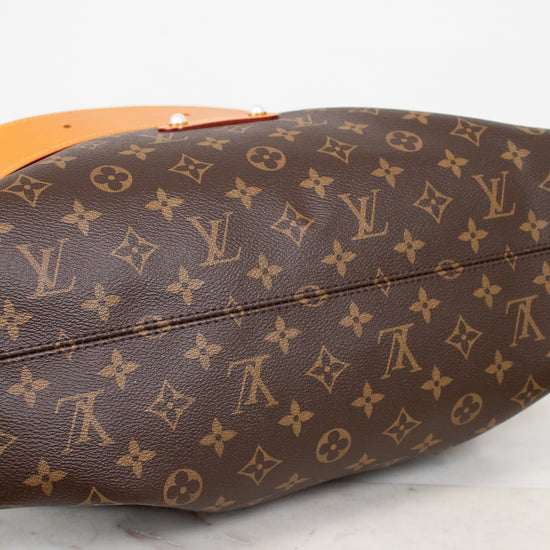 Brown Louis Vuitton monogram handbag on a light background