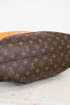 Brown Louis Vuitton monogram handbag on a light background