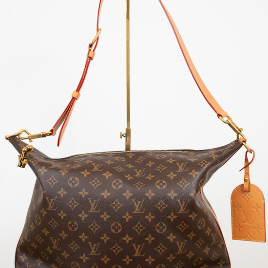 Designer handbag with monogram pattern on a white background