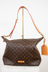 Designer handbag with monogram pattern on a white background