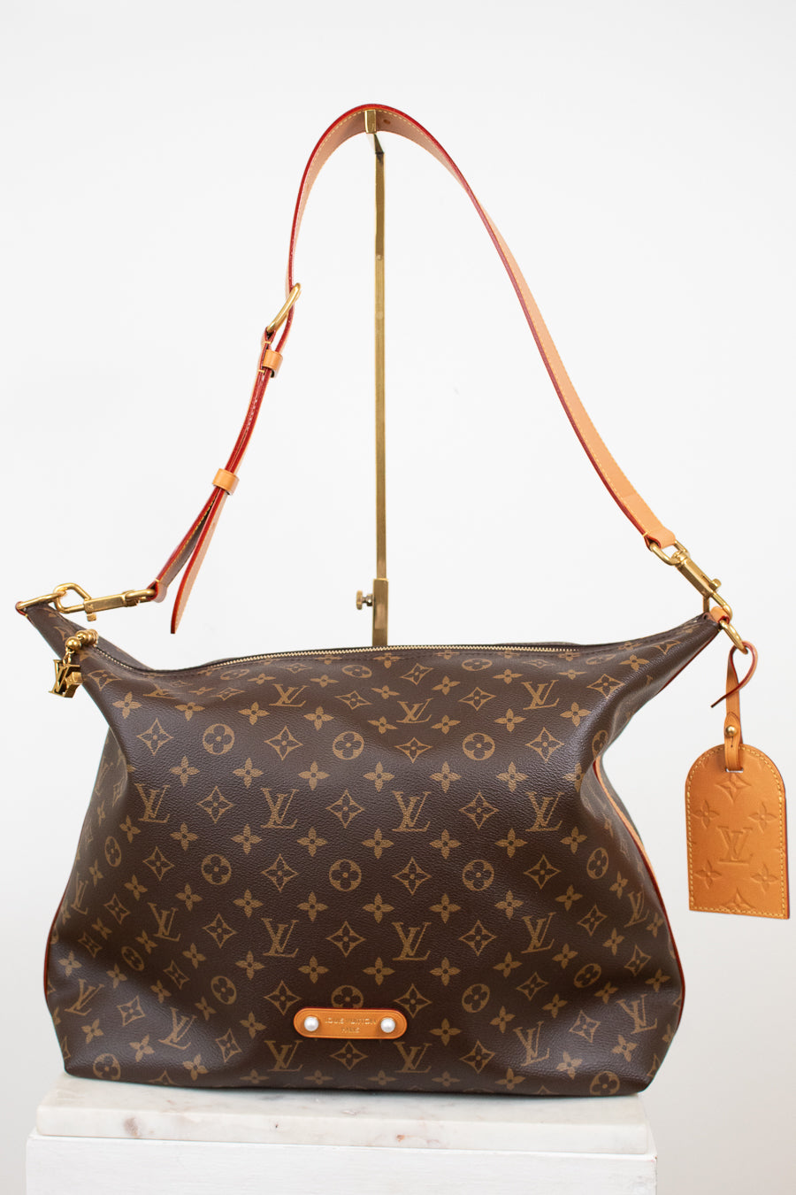 Designer handbag with monogram pattern on a white background