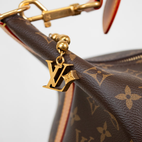 Close-up of a brown Louis Vuitton handbag with gold hardware and monogram pattern.