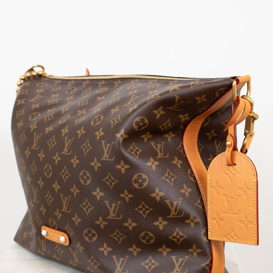 Designer handbag with monogram pattern on a white background