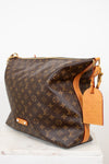 Designer handbag with monogram pattern on a white background