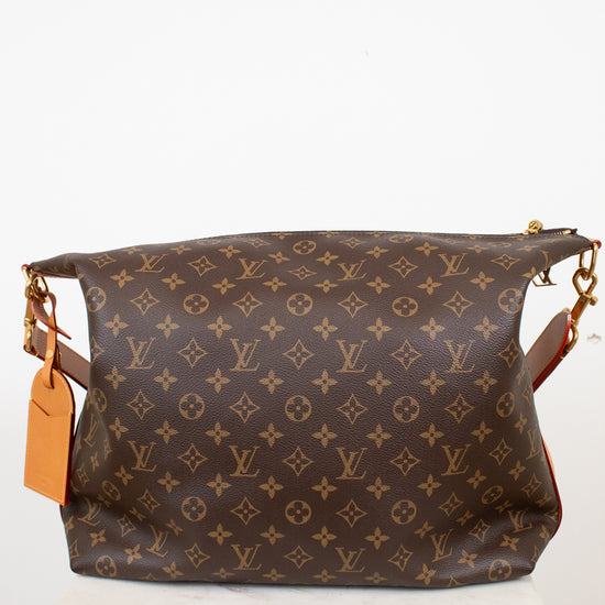 Brown monogram handbag with gold accents on a white background