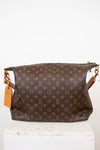 Brown monogram handbag with gold accents on a white background