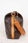 Louis Vuitton handbag with monogram pattern and brown strap on a white background
