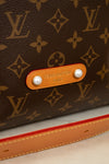 Close-up of a Louis Vuitton bag with monogram pattern and tan label.