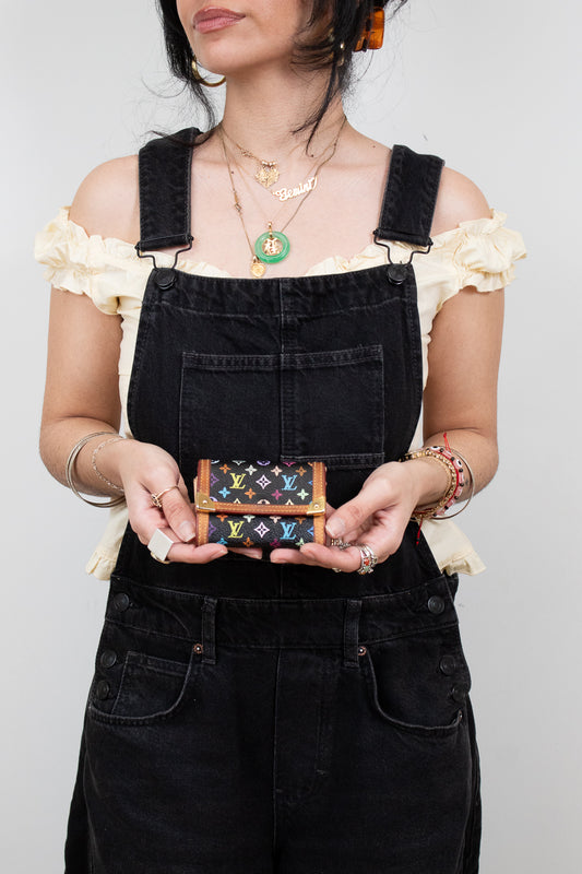 Person holding a colorful wallet with a plain background