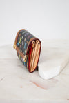 Designer wallet with colorful pattern on a marble surface