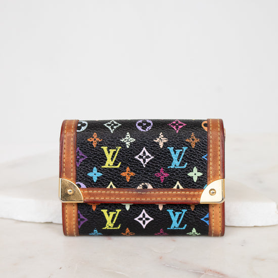 Black wallet with colorful monogram pattern on a white background