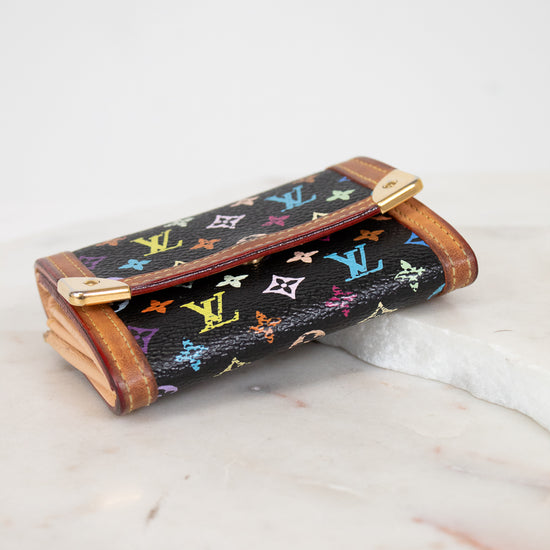 Louis Vuitton wallet with multicolor monogram pattern on a marble surface