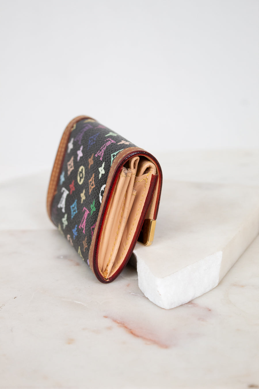 Small wallet with colorful pattern on a marble surface