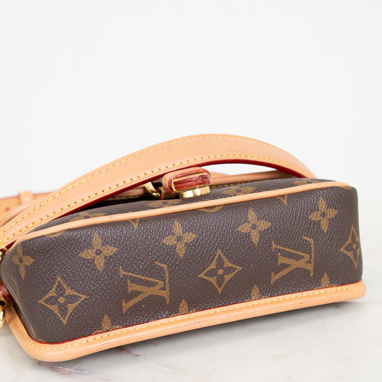 Louis Vuitton handbag with monogram pattern on a light background