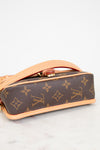 Louis Vuitton handbag with monogram pattern on a light background