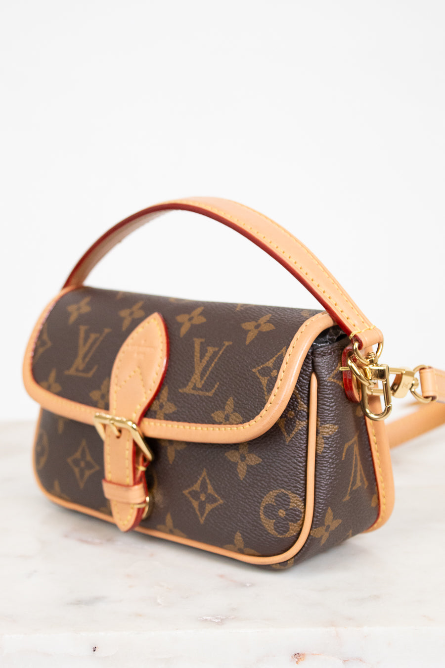 Louis Vuitton handbag with monogram pattern on a white background