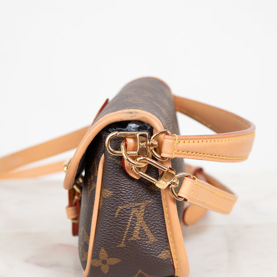 Louis Vuitton handbag with monogram pattern on a light background