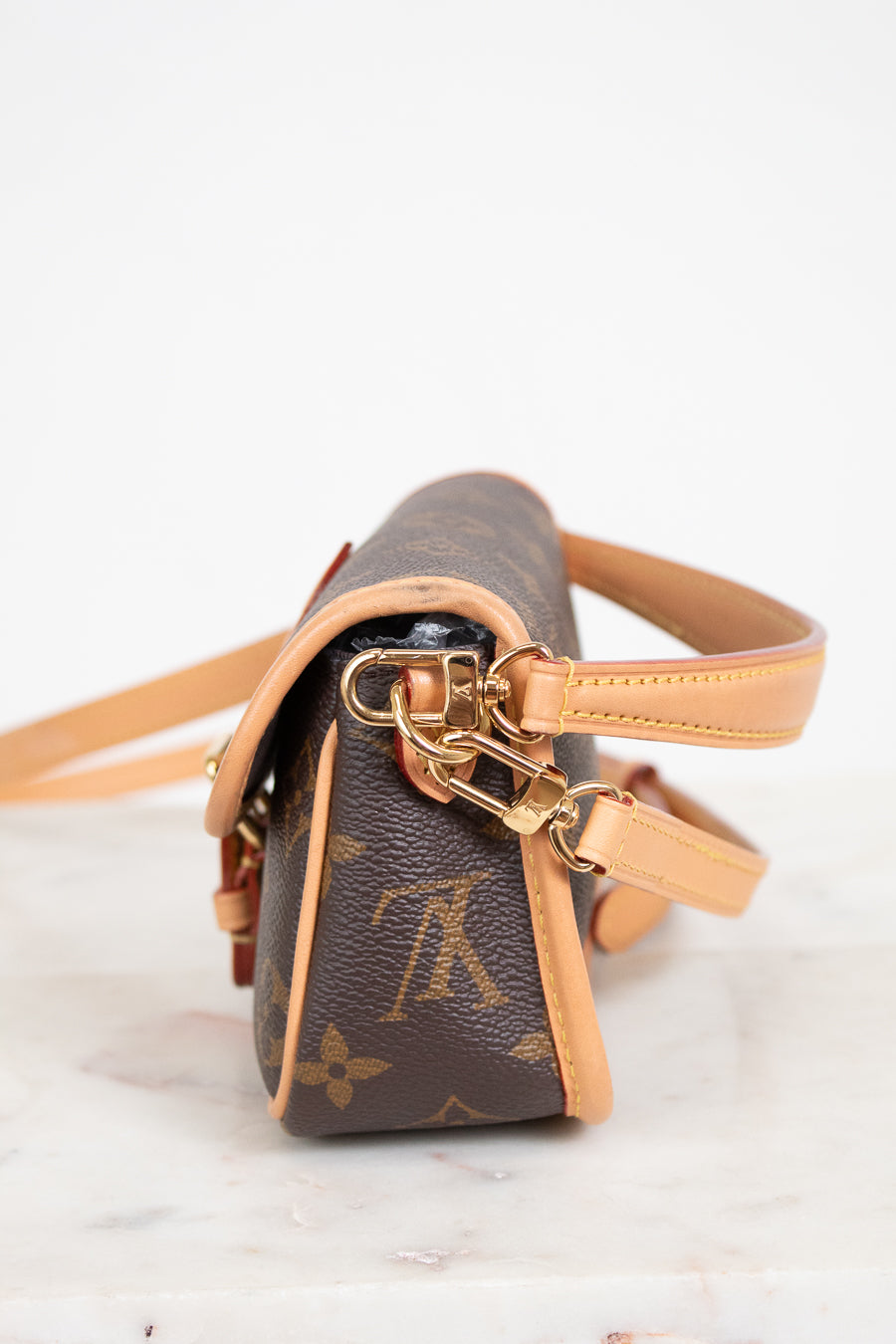 Louis Vuitton handbag with monogram pattern on a light background