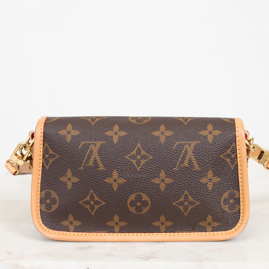 Brown handbag with gold chain strap on a white background