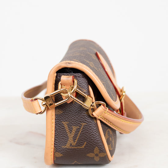 Louis Vuitton handbag with monogram pattern on a white background