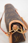 Close-up of a Louis Vuitton handbag with monogram pattern and gold chain detail.