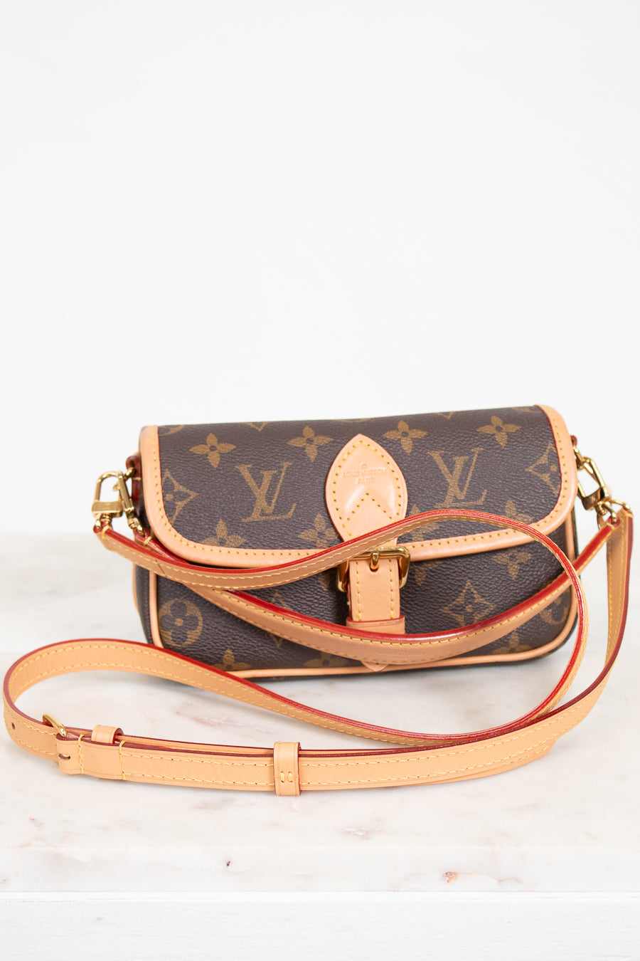 Designer handbag with monogram pattern on a white background