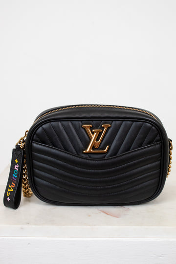 Black handbag with gold accents on a white background