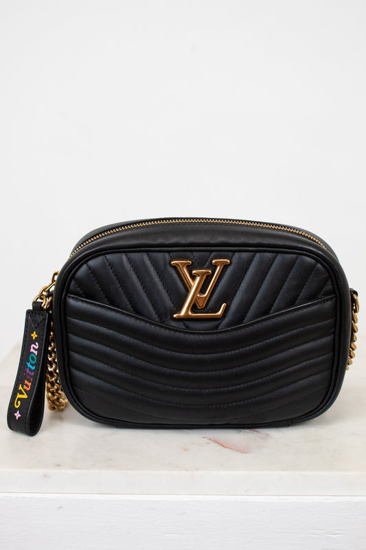 Black handbag with gold accents on a white background