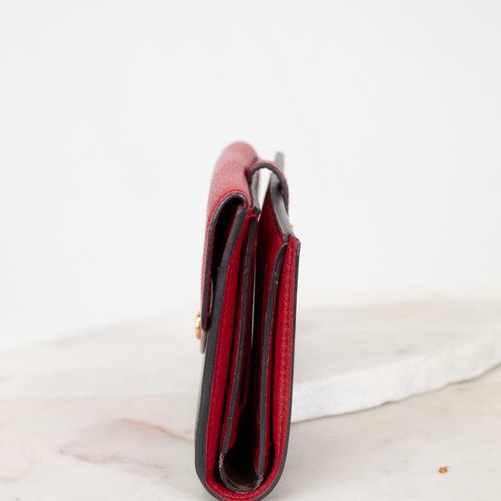 Red side of wallet on a marble surface
